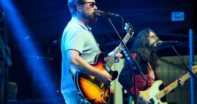 The Sheepdogs performing live at the 27th Annual Tim Hortons Southside Shuffle in Port Credit, with lead singer playing guitar on the Main Stage.
